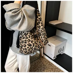Close-up of leopard print tote bag with plush texture and silver metal rings