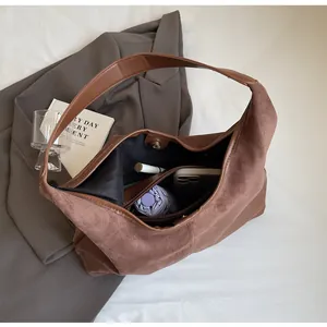 Detail view of large capacity dark brown matte tote bag with magnetic closure and items