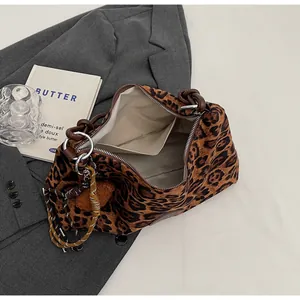 Detail shot of leopard tote bag with beige lining, silver zipper, and inner pocket