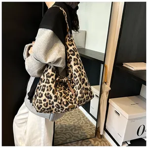 Detail view of leopard print tote bag featuring a decorative side bow and silver ring
