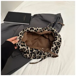 Detail of leopard print plush tote bag showing spacious interior and brown fabric lining