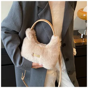 Close-up of fluffy faux fur handbag in beige featuring the Love every day engraved plaque