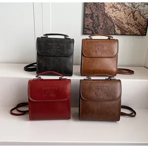 Four vintage matte leather backpacks in black, brown, wine red and coffee with flap texture