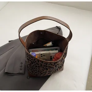 Top view of large leopard print tote bag with brown leather trim and spacious interior