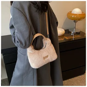 Detail view of the soft faux fur bag texture with leather handle and metal logo plate