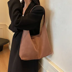 Minimalist brown suede tote bag for women featuring a wide strap and spacious design
