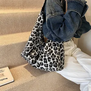 Chic leopard print plush tote bag with bow detail for women in a casual autumn setting