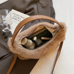 Internal view of brown faux fur handbag showing space for phone and cosmetics