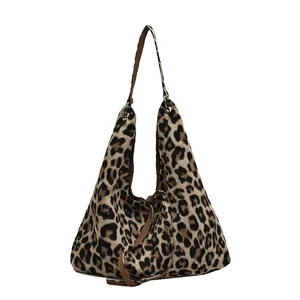 Leopard print large capacity tote bag with brown straps and soft plush texture