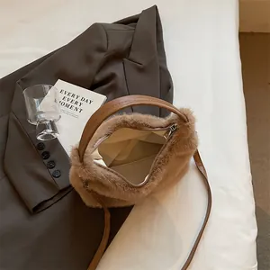 Detail of plush faux fur handbag in khaki with leather handles and interior lining