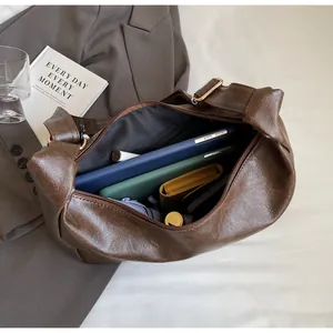 Interior storage view of large brown faux leather tote bag with tablet and wallet