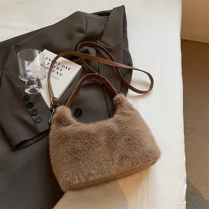 Detail of soft khaki faux fur handbag with synthetic leather straps on a grey blazer