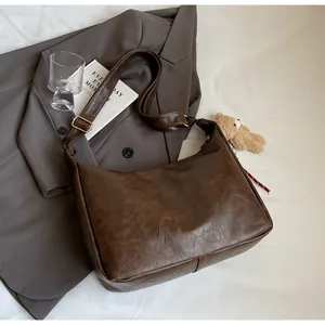 Macro detail of dark brown leather texture and adjustable strap on retro shoulder bag