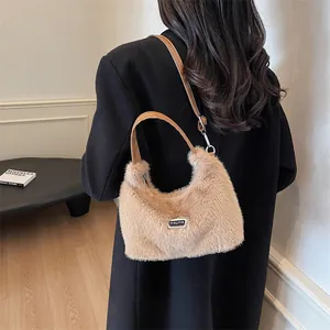 Faux fur plush shoulder bag in khaki with leather strap shown in a lifestyle setting