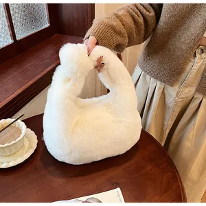 Close-up of soft white faux fur texture on this stylish plush handbag for winter fashion