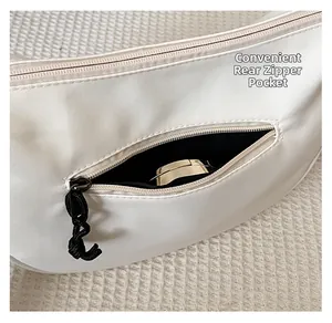 Vue détaillée de la poche arrière zippée sur un sac blanc cassé montrant le rangement
