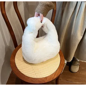 Close-up of soft white faux fur handbag texture and minimalist integrated handle design