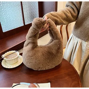 Detailed view of a soft brown plush handbag on a wooden desk with cozy autumn vibes