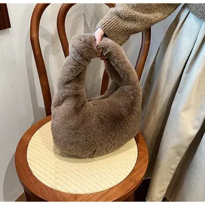 Close-up of fluffy faux fur handbag in khaki showing soft texture and cozy handle