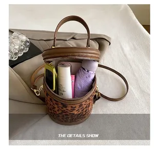 Internal capacity of leopard print cylinder bag with phone, umbrella and cosmetics