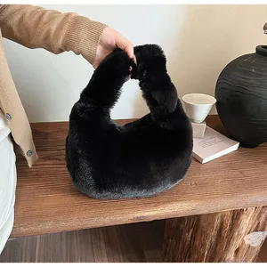 Close-up of black faux fur handbag with plush texture on a dark wooden table background