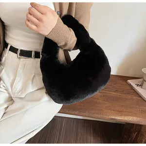 Detail view of a black fluffy faux fur handbag paired with a cozy autumn outfit