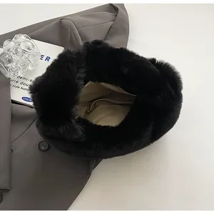 Detail shot of black faux fur plush handbag showing soft texture and inner lining fabric