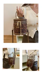 Close-up of leopard print bucket bag featuring gold zippers and metal rivet detailing