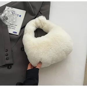 Detail of white faux fur handbag with soft texture on a grey blazer background