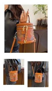 Detailed close-up of patchwork leather bucket bag showing zip closure and golden hardware