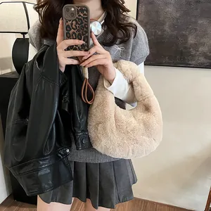 Chic beige faux fur handbag paired with casual autumn outfit in a cozy indoor setting