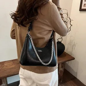 Fashionable black underarm bag with cracked texture and silver chain strap for women