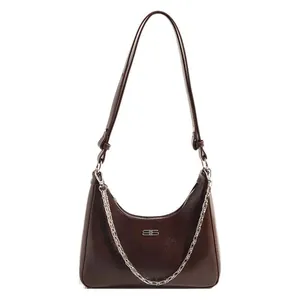 Dark brown leather underarm bag with silver chain and metal logo on white background
