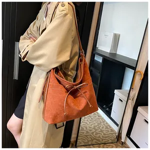 Detail of vintage matte suede tote bag in brown orange with delicate bow decoration