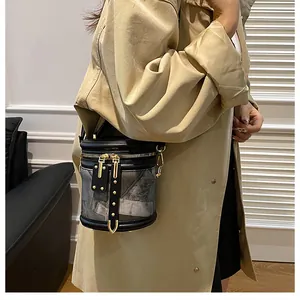 Detail view of stylish marbled bucket bag with gold zippers and metal hardware