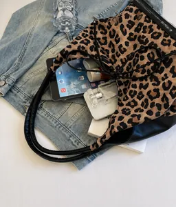 Leopard print tote bag interior view showcasing large capacity and leather details