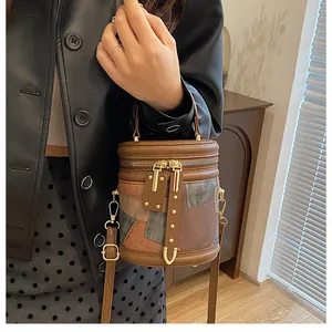 Detail of a vintage patchwork bucket bag with metal hardware shown in a lifestyle setting