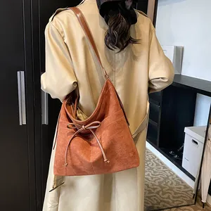 Caramel brown suede hobo tote bag with bow detail and white stitching for women