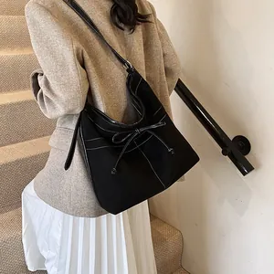 Retro black matte tote bag with white contrast stitching and bow detail for women