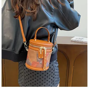 Close-up of a vintage patchwork bucket bag showing textures and gold rivet details