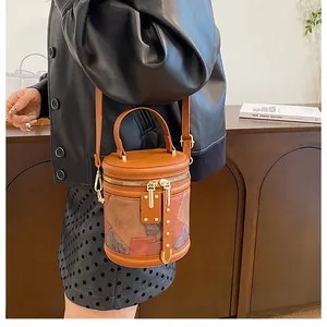 Detail view of a color-block bucket bag with gold hardware in a modern home setting