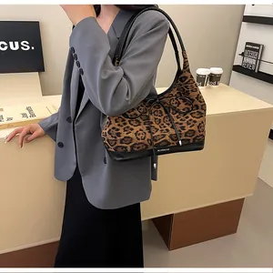 Detailed view of leopard print faux fur tote bag with black leather base and bow detail