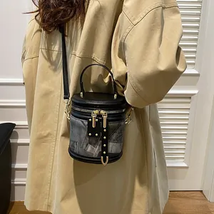 Fashionable cylinder bucket bag in retro print with gold hardware and top handle