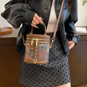 Vintage patchwork leather bucket bag with top handle and crossbody strap for women