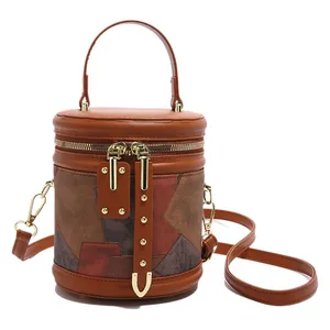 Retro brown cylinder bucket bag with colorful patchwork leather and gold hardware