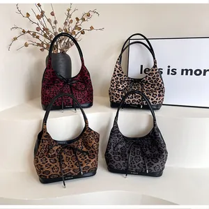 Detail showing leopard print tote bags in red, brown, beige and grey with bow accents