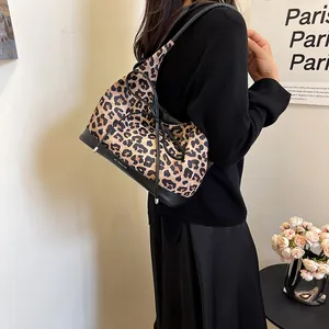 Leopard print tote bag with black leather straps and decorative bow for women