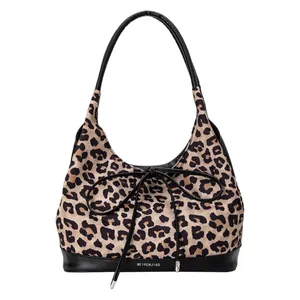 Contrast leopard print tote bag with black leather base and decorative bow detail