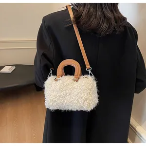 On-body view of a mini plush crossbody bag with cream fleece and brown leather strap