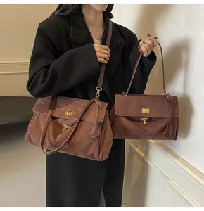 Dettaglio borse shopper vintage in pelle scamosciata marrone con chiusura dorata